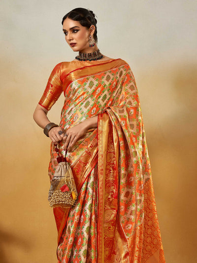 Orange–Gold Banarasi satin silk saree with zari work and woven parrot motifs, styled for traditional Indian wedding rituals with luxury finish. Orange–Gold Banarasi satin silk saree with zari work and woven parrot motifs, styled for traditional Indian wedding rituals with luxury finish..