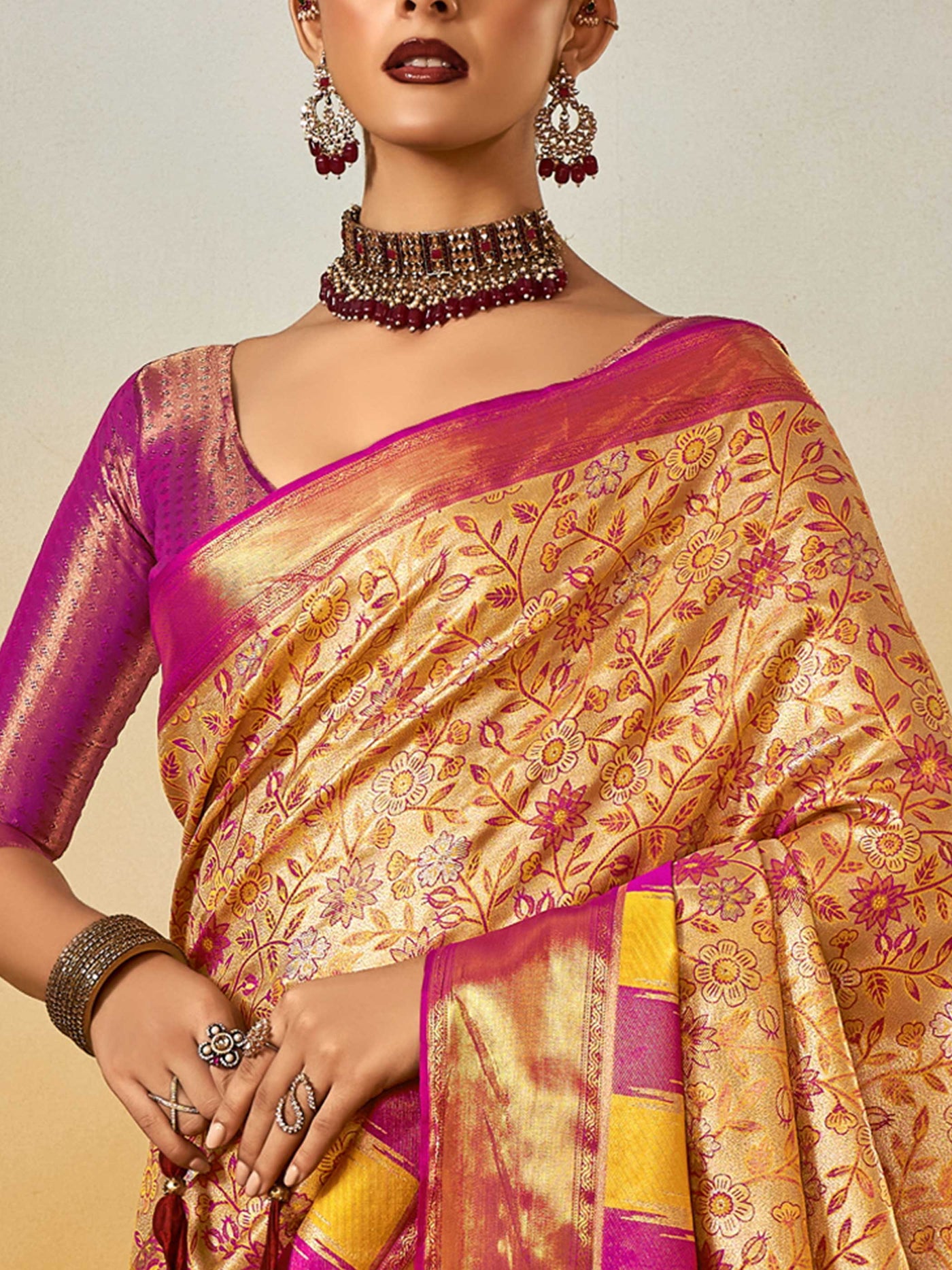Beige–Magenta Banarasi satin silk saree with zari work and woven parrot motifs, styled for traditional Indian wedding rituals with luxury finish. Beige–Magenta Banarasi satin silk saree with zari work and woven parrot motifs, styled for traditional Indian wedding rituals with luxury finish..