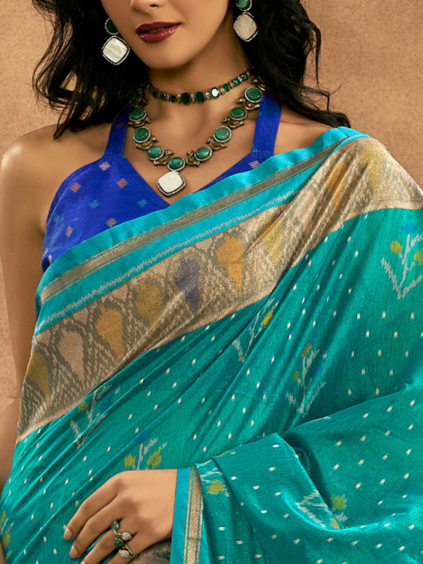 Teal Blue–Royal Blue Banarasi silk saree with Patola-inspired design and rich zari border, styled for wedding glamour and traditional elegance. Teal Blue–Royal Blue Banarasi silk saree with Patola-inspired design and rich zari border, styled for wedding glamour and traditional elegance..