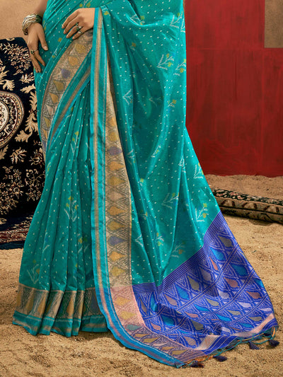 Teal Blue–Royal Blue Banarasi silk saree with Patola-inspired design and rich zari border, styled for wedding glamour and traditional elegance. Teal Blue–Royal Blue Banarasi silk saree with Patola-inspired design and rich zari border, styled for wedding glamour and traditional elegance..