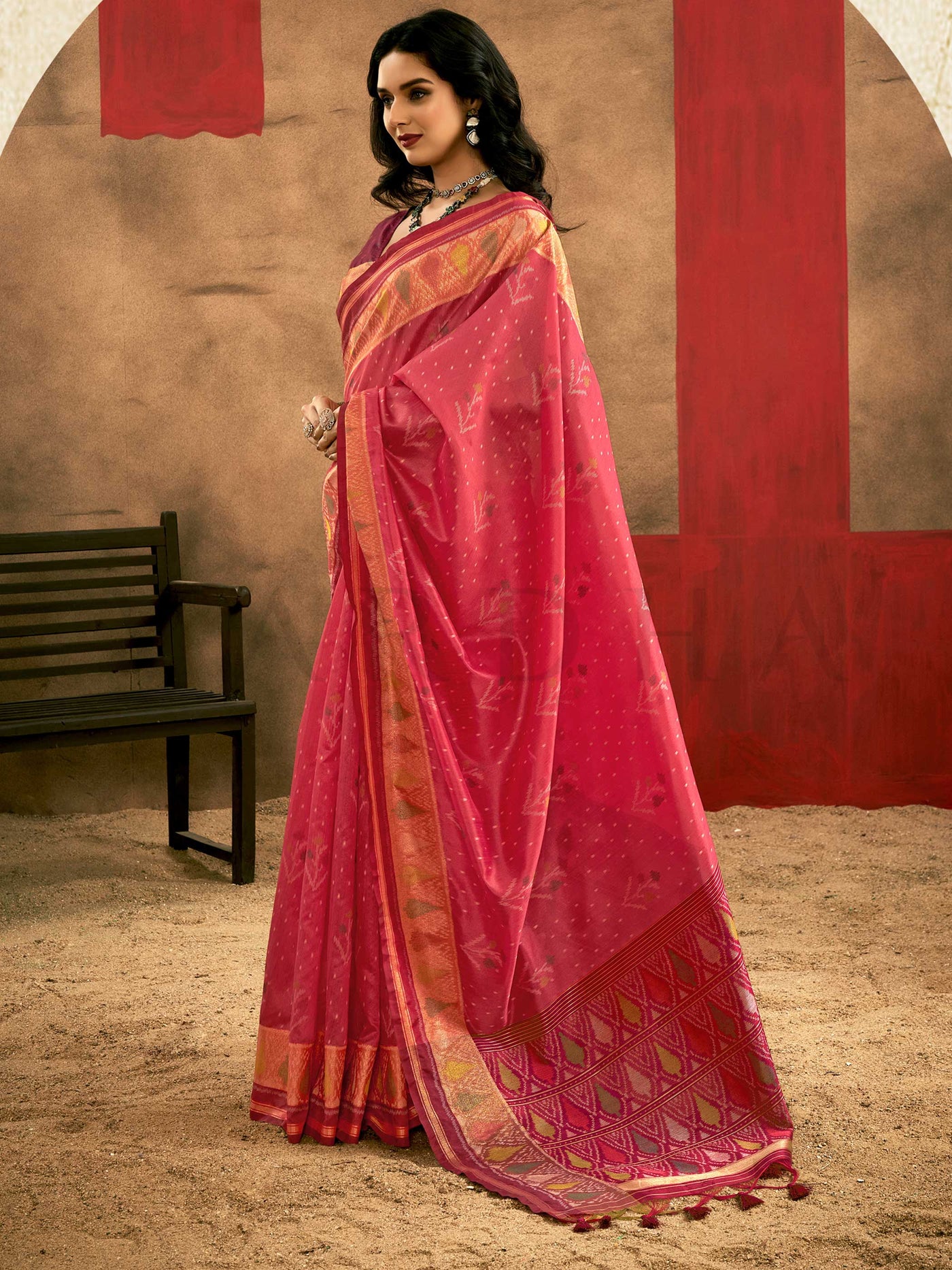Crimson Pink–Burnt Orange Banarasi silk saree with Patola-inspired design and rich zari border, styled for wedding glamour and traditional elegance. Crimson Pink–Burnt Orange Banarasi silk saree with Patola-inspired design and rich zari border, styled for wedding glamour and traditional elegance..