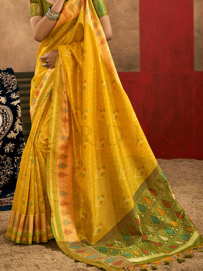 Sunflower Yellow–Leaf Green Banarasi silk saree with Patola-inspired design and rich zari border, styled for wedding glamour and traditional elegance. Sunflower Yellow–Leaf Green Banarasi silk saree with Patola-inspired design and rich zari border, styled for wedding glamour and traditional elegance..
