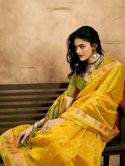 Sunflower Yellow–Leaf Green Banarasi silk saree with Patola-inspired design and rich zari border, styled for wedding glamour and traditional elegance.