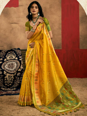 Sunflower Yellow–Leaf Green Banarasi silk saree with Patola-inspired design and rich zari border, styled for wedding glamour and traditional elegance. Sunflower Yellow–Leaf Green Banarasi silk saree with Patola-inspired design and rich zari border, styled for wedding glamour and traditional elegance..