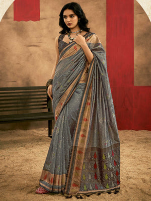 Slate Grey–Multi Zari Banarasi silk saree with Patola-inspired design and rich zari border, styled for wedding glamour and traditional elegance. Slate Grey–Multi Zari Banarasi silk saree with Patola-inspired design and rich zari border, styled for wedding glamour and traditional elegance..