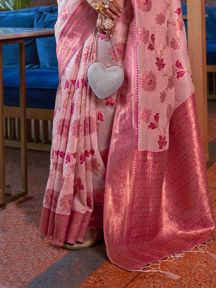 Luxurious Baby Pink Shimmer Organza Saree enriched with Copper Zari Weaving and a Contrast Border, ensuring a Graceful Drape—suitable for Traditional Functions and Modern Festivities. 
