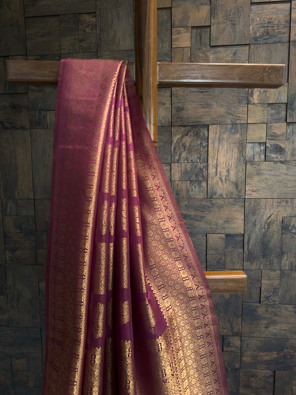 Close-up of the vertical gold zari floral creeper stripes on the magenta body.