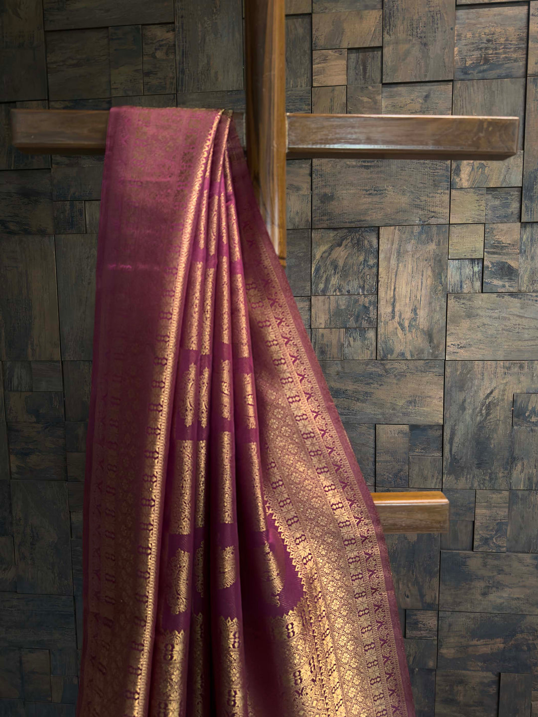 Close-up of the vertical gold zari floral creeper stripes on the magenta body.