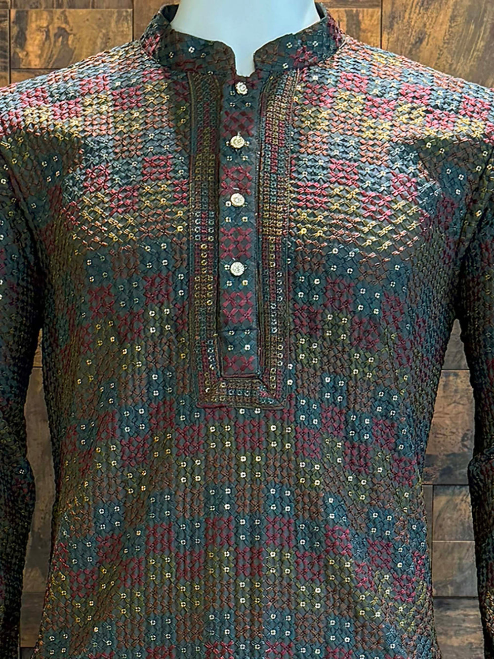 Designer men’s kurta featuring teal, maroon, and olive woven details with shimmer highlights.