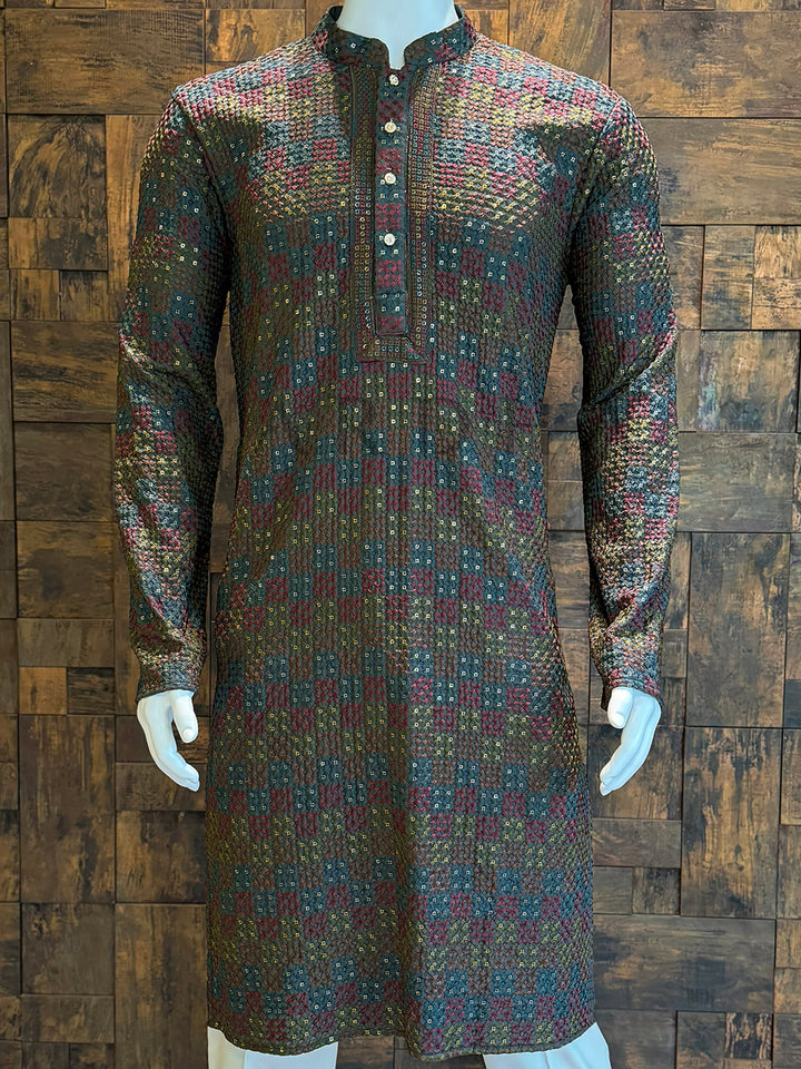 Patterned kurta on a mannequin against a wooden paneled wall Elegant full-sleeve viscose kurta perfect for weddings, parties, and festive functions. Traditional dark base kurta with golden shimmer weaving and geometric artistry.