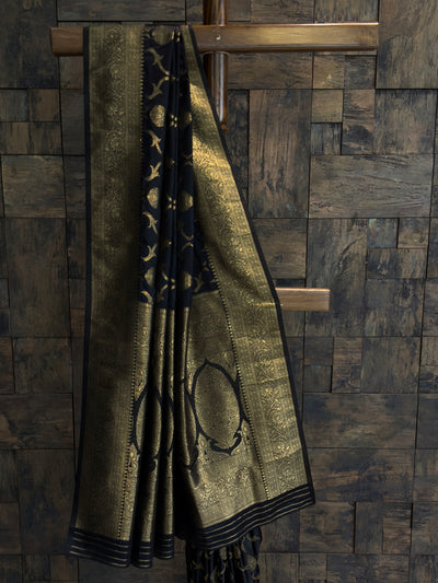 Elegant black and gold Banarasi silk saree featuring heavy zari work and broad pallu