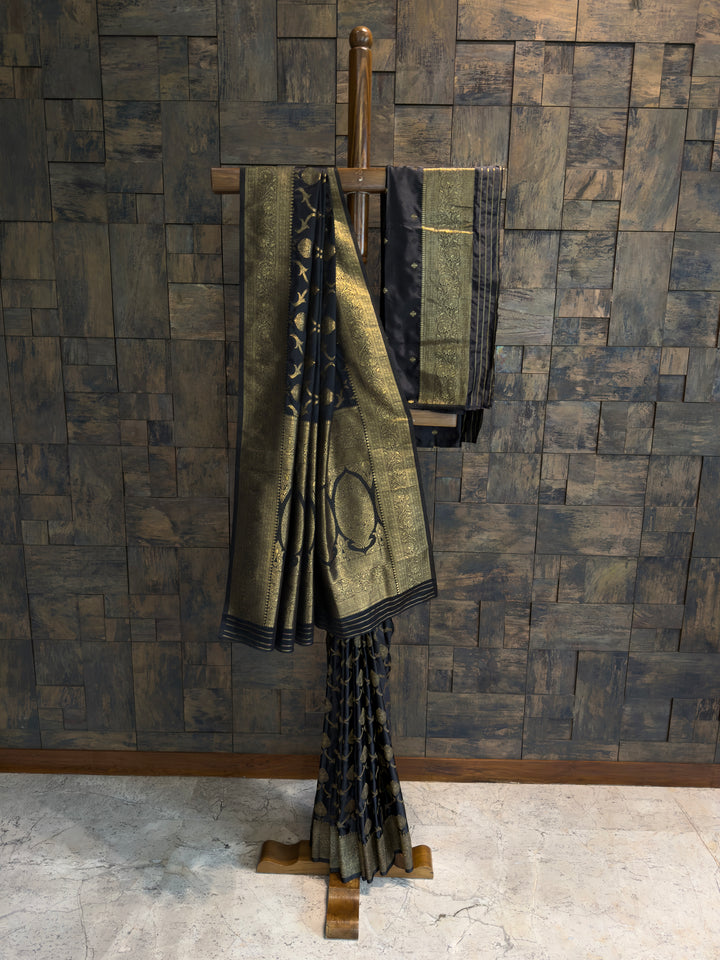Festive Banarasi silk saree in black and gold with rich zari patterns on pallu and pleats