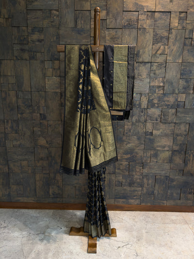 Festive Banarasi silk saree in black and gold with rich zari patterns on pallu and pleats