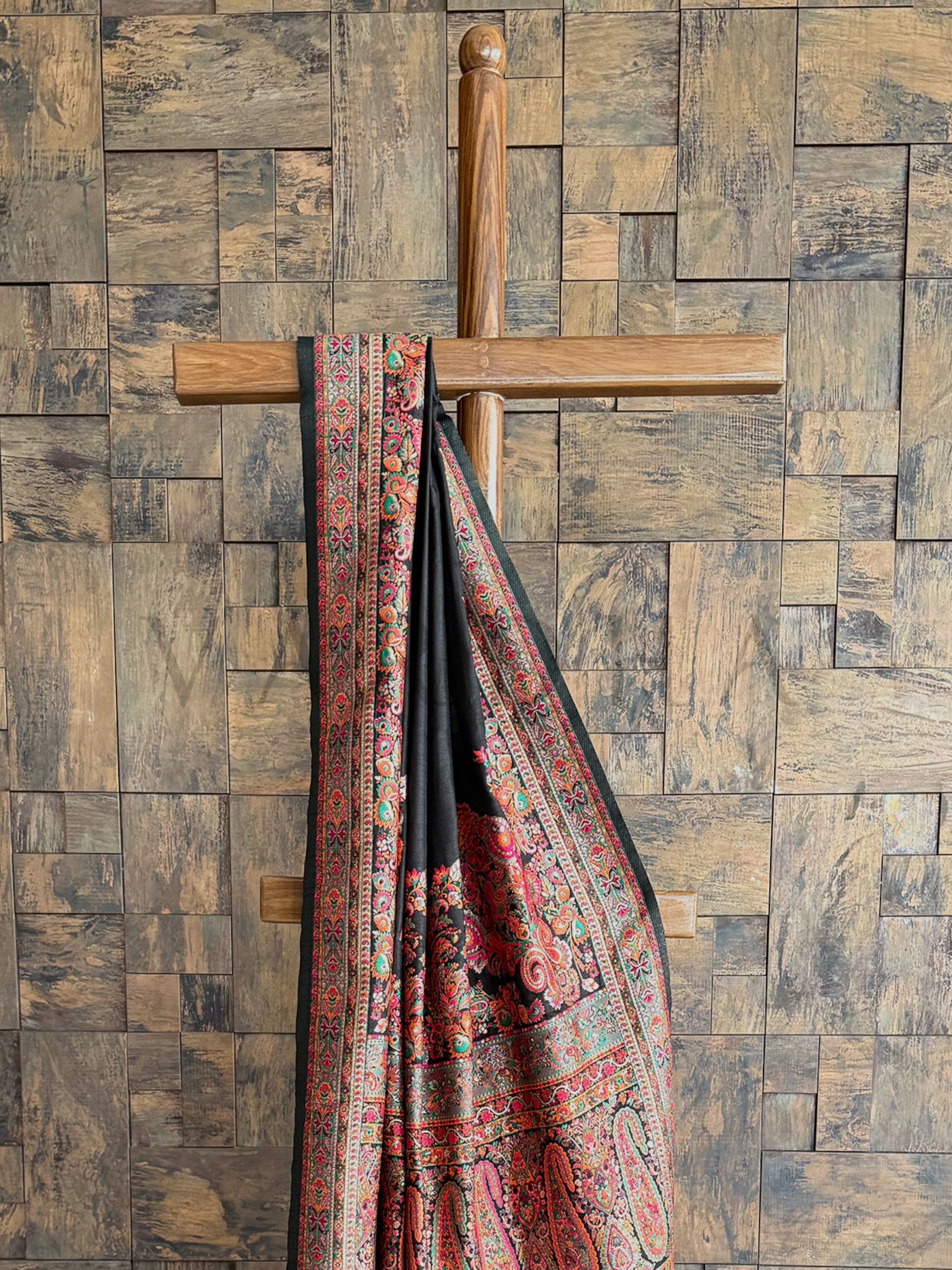 Sophisticated black Pashmina raw silk saree adorned with exquisite embossed thread detailing for a regal look