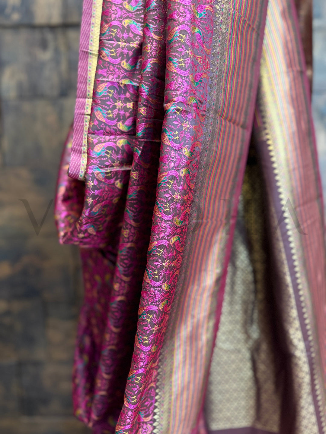 Detailed view of parrot motif thread weave on black satin silk saree with traditional zari finish and vibrant embroidery work