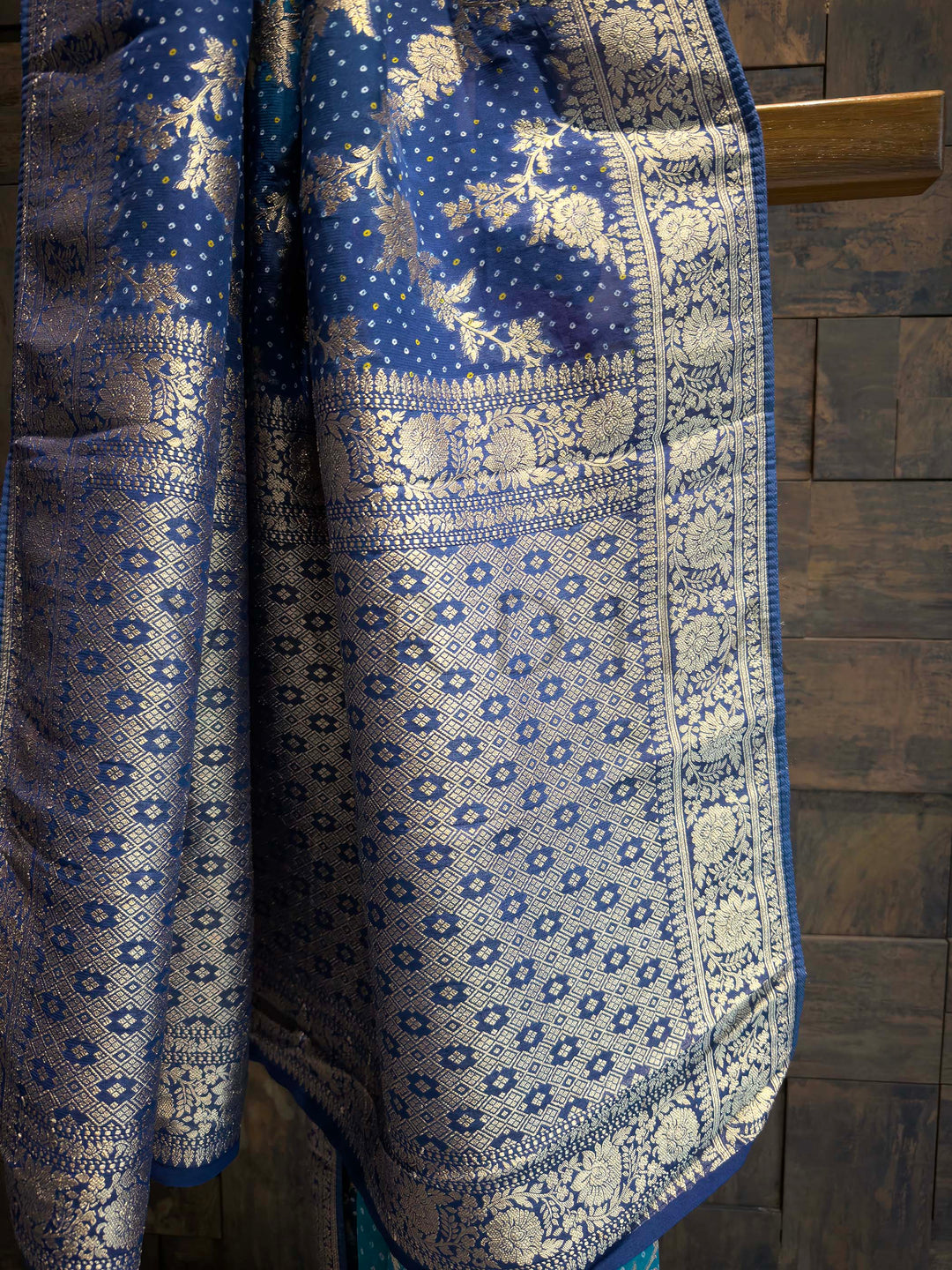 Blue and white patterned fabric draped over a wooden surface