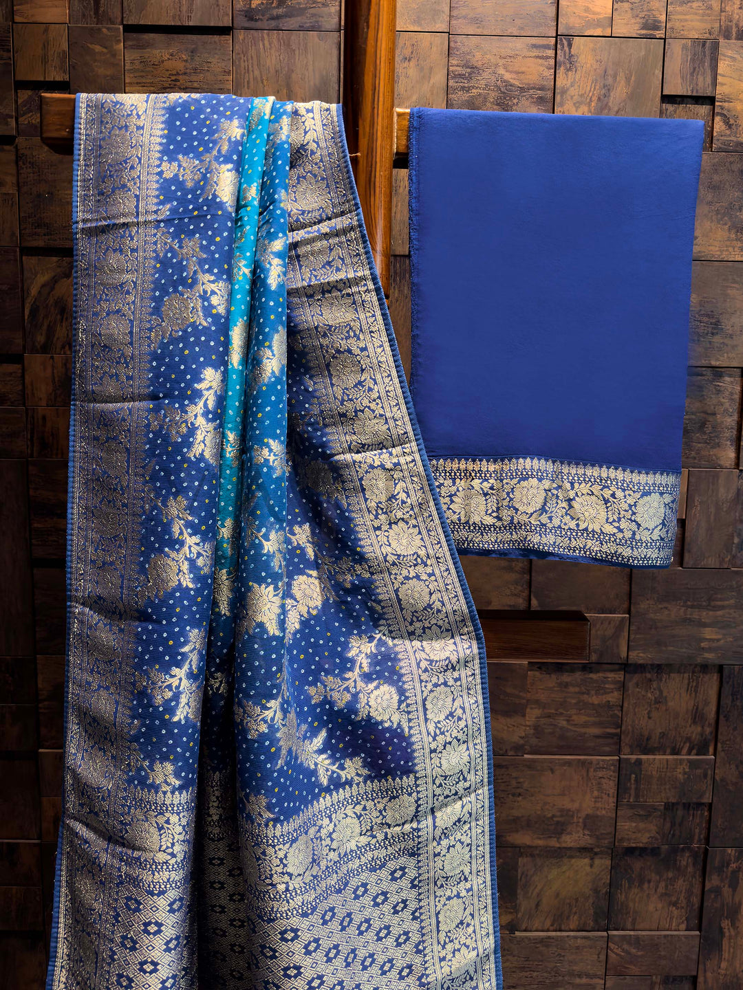 Two blue patterned fabrics on a wooden background