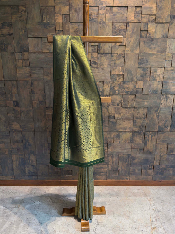 House of Vardha designer green silk saree with traditional gold Kanjivaram weaving, ideal for bridal and festive Indian wear. Bottle Green Golden Zari Kanjivaram Silk Saree House of Vardha