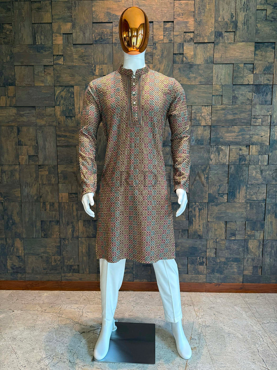 Mannequin wearing a patterned kurta against a textured wall. Multicolor viscose kurta with geometric woven design and embroidered placket for festive wear.