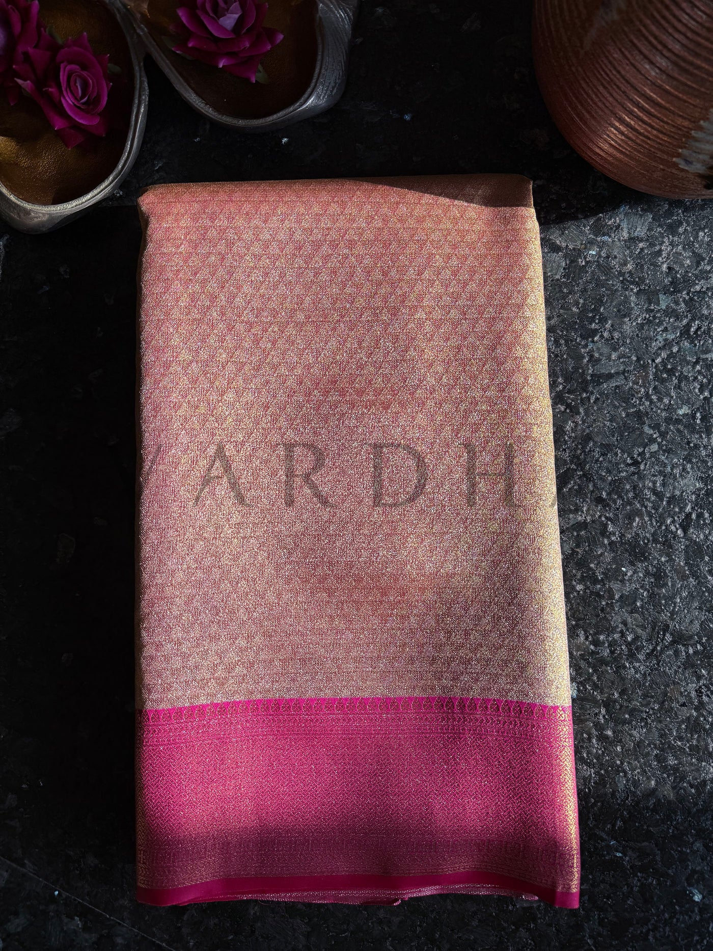 Folded view highlighting diamond weave pattern on beige body with magenta zari border

