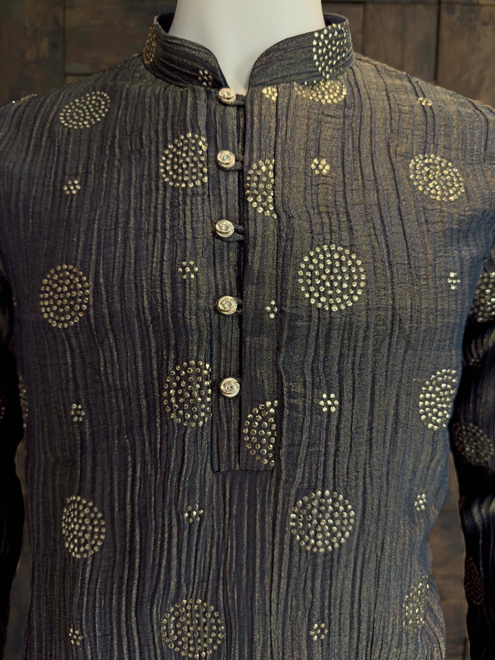 Close up of Mandarin Collar and Fancy Buttons on Designer Blue Viscose Kurta. Dark gray traditional outfit with gold embroidery on a wooden background