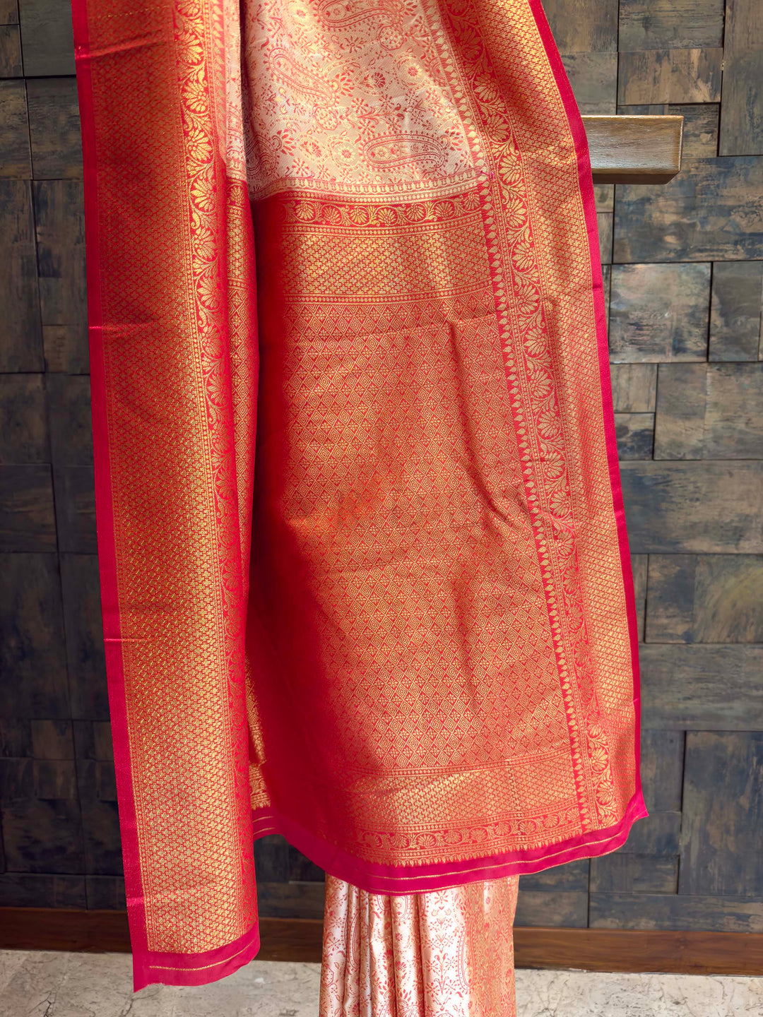 Detail shot of the Red Gold Zari border contrasting with the cream body.
