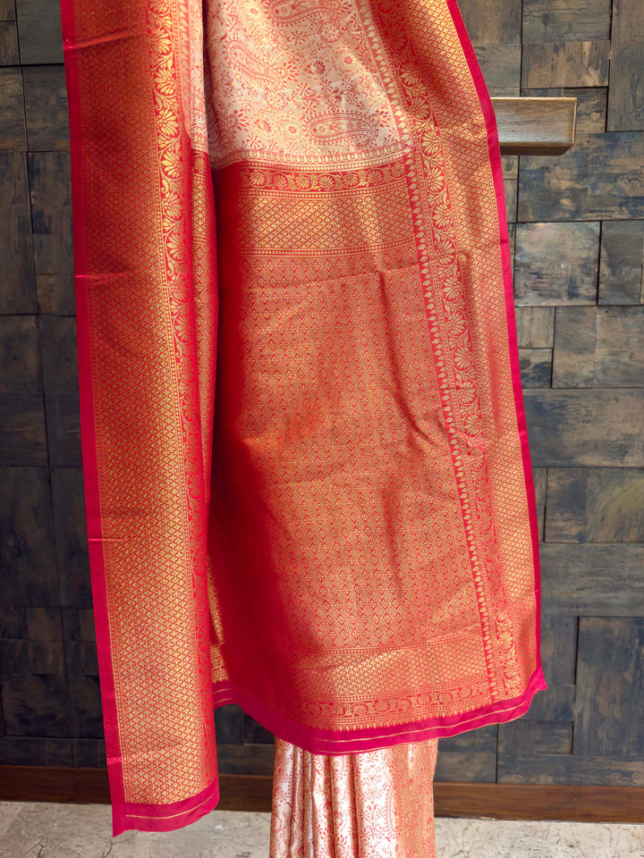 Detail shot of the Red Gold Zari border contrasting with the cream body.
