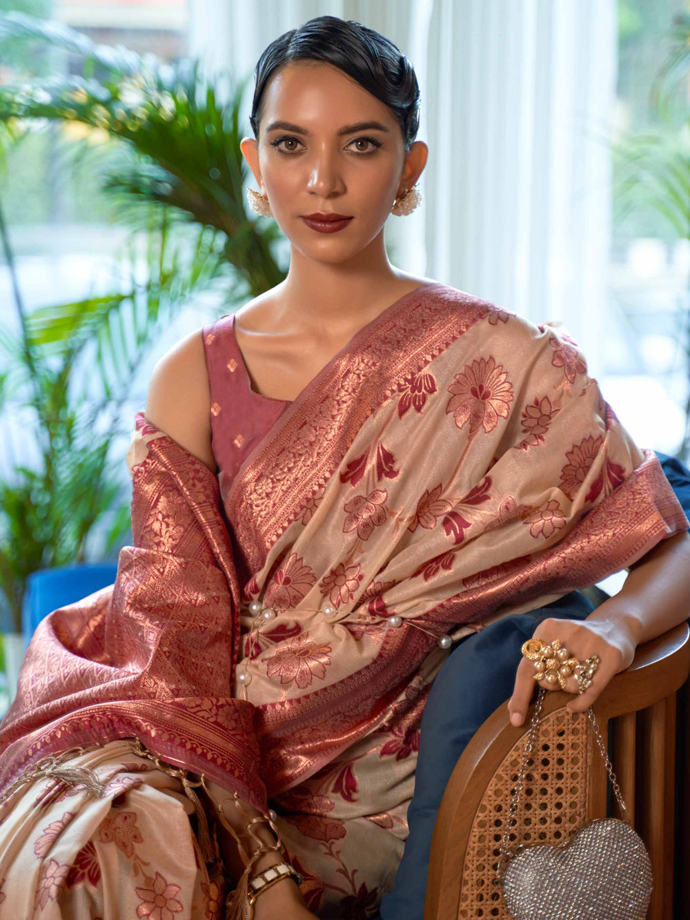 Elegant Cream Organza Silk Saree adorned with Intricate Zari Weaving and a Heavy Border, offering a Luxurious Drape—ideal for those seeking Authentic Ethnic Wear with a Contemporary Touch. 
