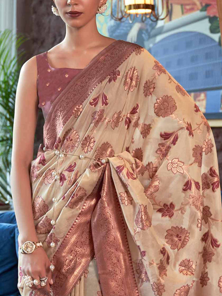 Handcrafted Cream Organza Chikankari Saree with Zari Lucknowi Handloom Weaving and a Contrast Woven Border, showcasing Traditional Phool Bel Motifs—a statement piece for Cultural Celebrations and Special Events. 
