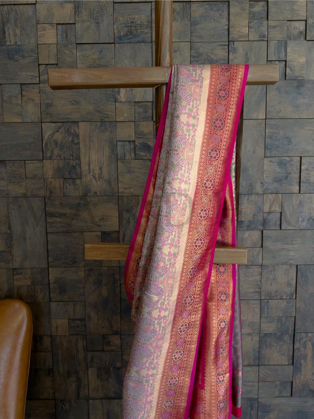 Elegant art silk saree with zari floral border and intricate peacock kalamkari Heritage inspired cream saree with handwoven kalamkari detailing and pink brocade
