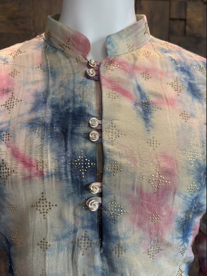 Close-up of men’s designer kurta featuring mandarin collar, ornate buttons, pastel tie-dye texture in blue and pink tones, and delicate gold motif detailing.