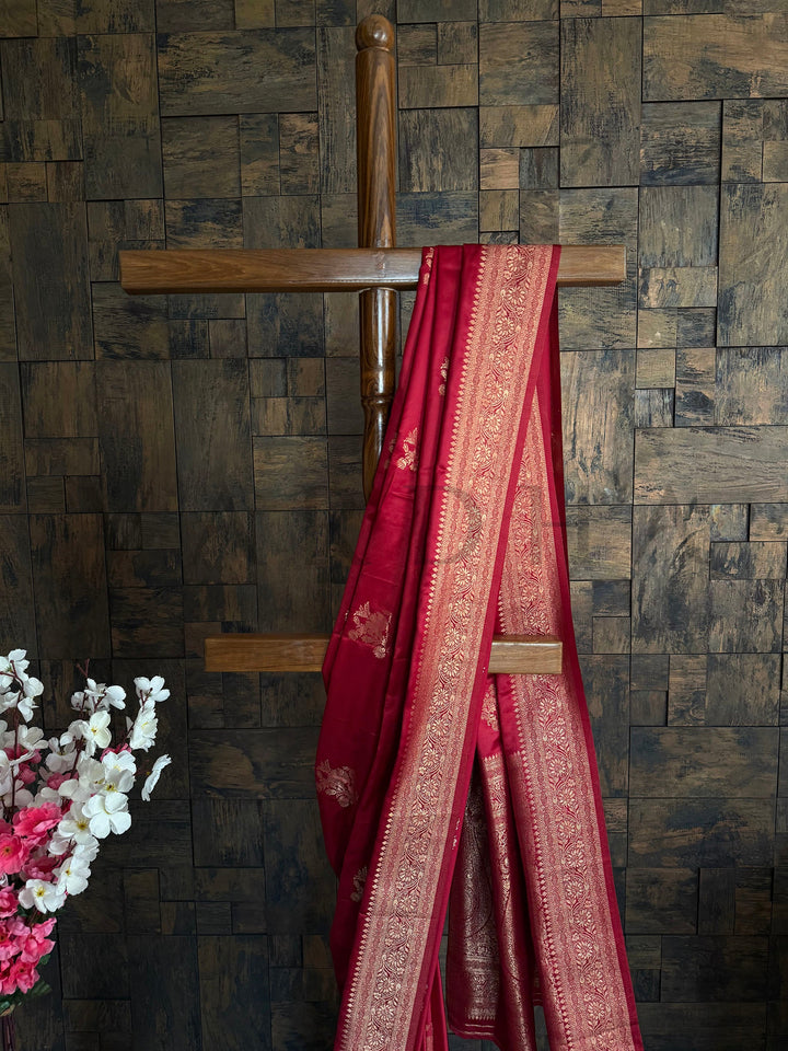 Satin saree for Diwali and rituals in red with copper gold embroidery. Authentic Indian ethnic wear featuring a striking Deep Maroon Satin Saree richly woven with golden threads to create a luxurious look by House of Vardha. We offer Ready to wear, Pre drape service, Saree Add on, Custom Stitched Blouse, Fall and Edging, Gift Packaging at Complimentary Price!