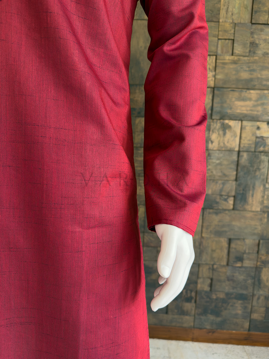 Maroon garment with a textured pattern on a wooden floor background. Close-up of the full sleeve and side drape of the rich maroon textured cotton kurta, showcasing the breathable premium fabric and clean, elegant minimalist aesthetic.