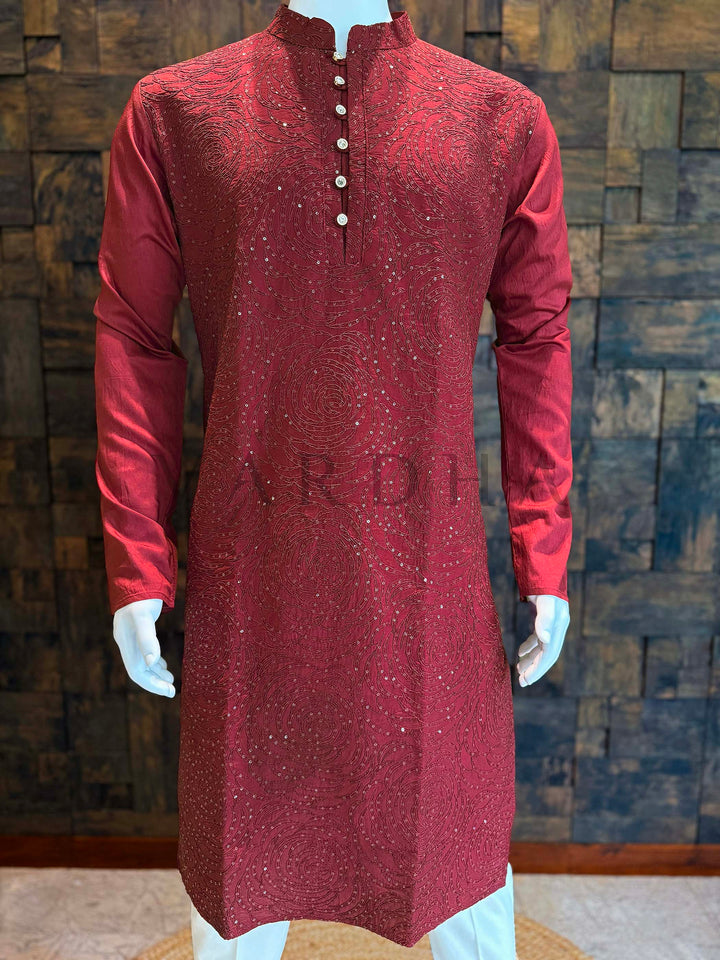 Maroon kurta with white buttons on a mannequin against a wooden paneled wall. Deep_Maroon_Viscose_Kurta_with_Rosette_Sequin_Embroidery-MLK137_MRN-2

