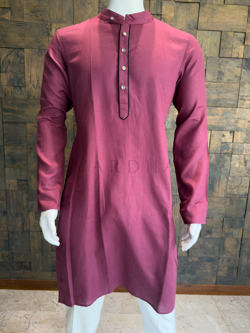 Close-up of the deep mauve kurta showing the contrast piped placket and crisp mandarin collar.