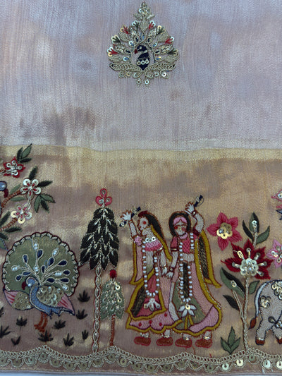 Delicate floral butta detailing scattered across soft tissue silk body—lightweight and festive with emotional symbolism.
