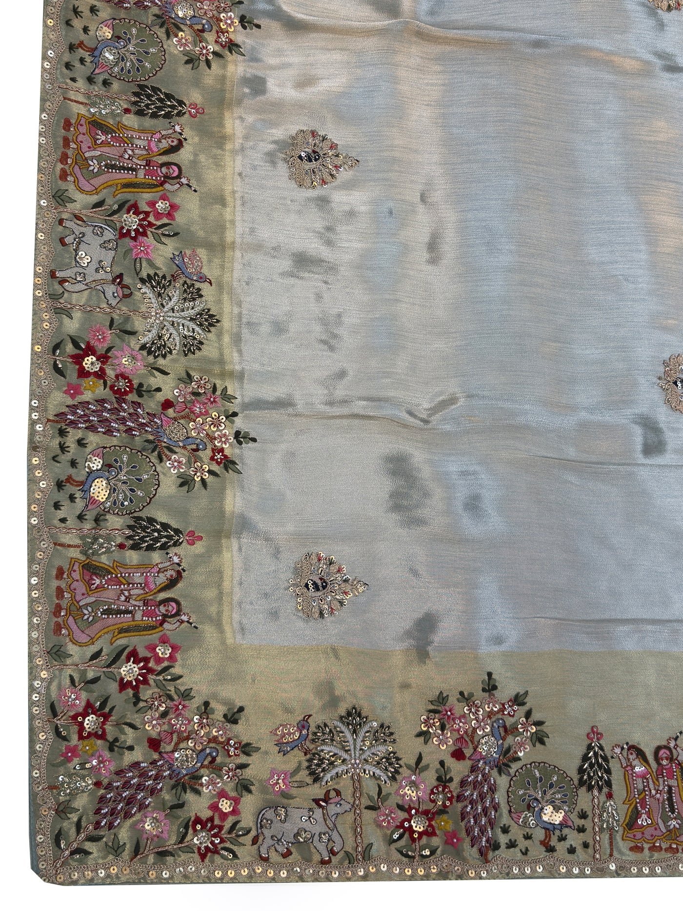 Mythological art detailing in thread, mirror, and zari work forming the pallu design on soft silk fabric—wedding or pooja ready.
