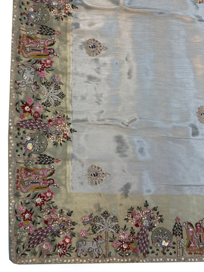 Mythological art detailing in thread, mirror, and zari work forming the pallu design on soft silk fabric—wedding or pooja ready.
