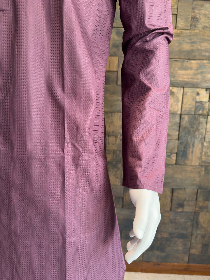 Purple textured garment on a mannequin against a wooden paneled wall. Elegant Dusty Mauve cotton kurta for men, an ideal choice for daytime weddings, festive brunches, or evening cultural celebrations.