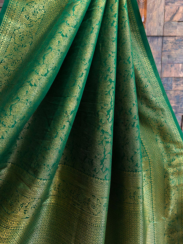 Angled shot of saree pallu revealing heavy woven zari work with floral and geometric patterns, luminous Kanjivaram art silk suitable for weddings, parties, and sangeet nights.