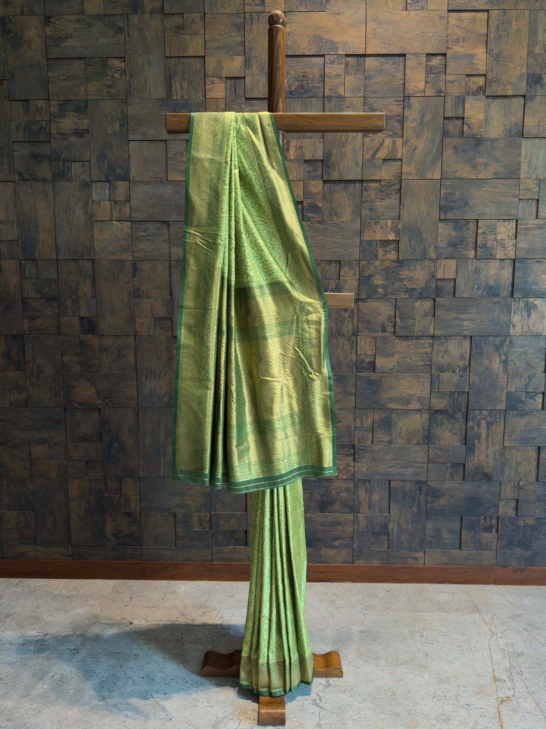 Full draped view of Emerald Green Tanchoi Satin Silk saree on mannequin.