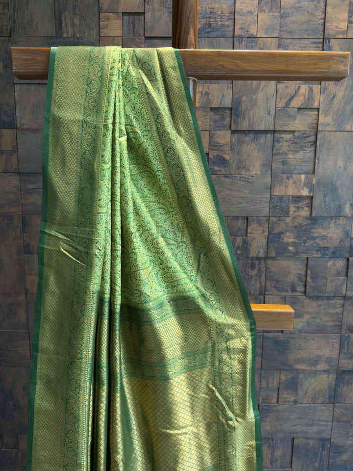 Close-up of the green satin body showing self-woven paisley motifs.