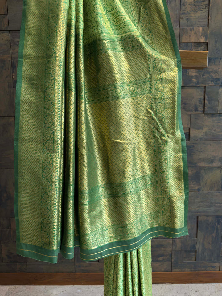Detail shot of the Gold Zari border blending with the green body.
