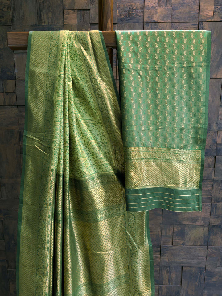 Saree with matching Green blouse piece featuring all-over zari paisley buttis.