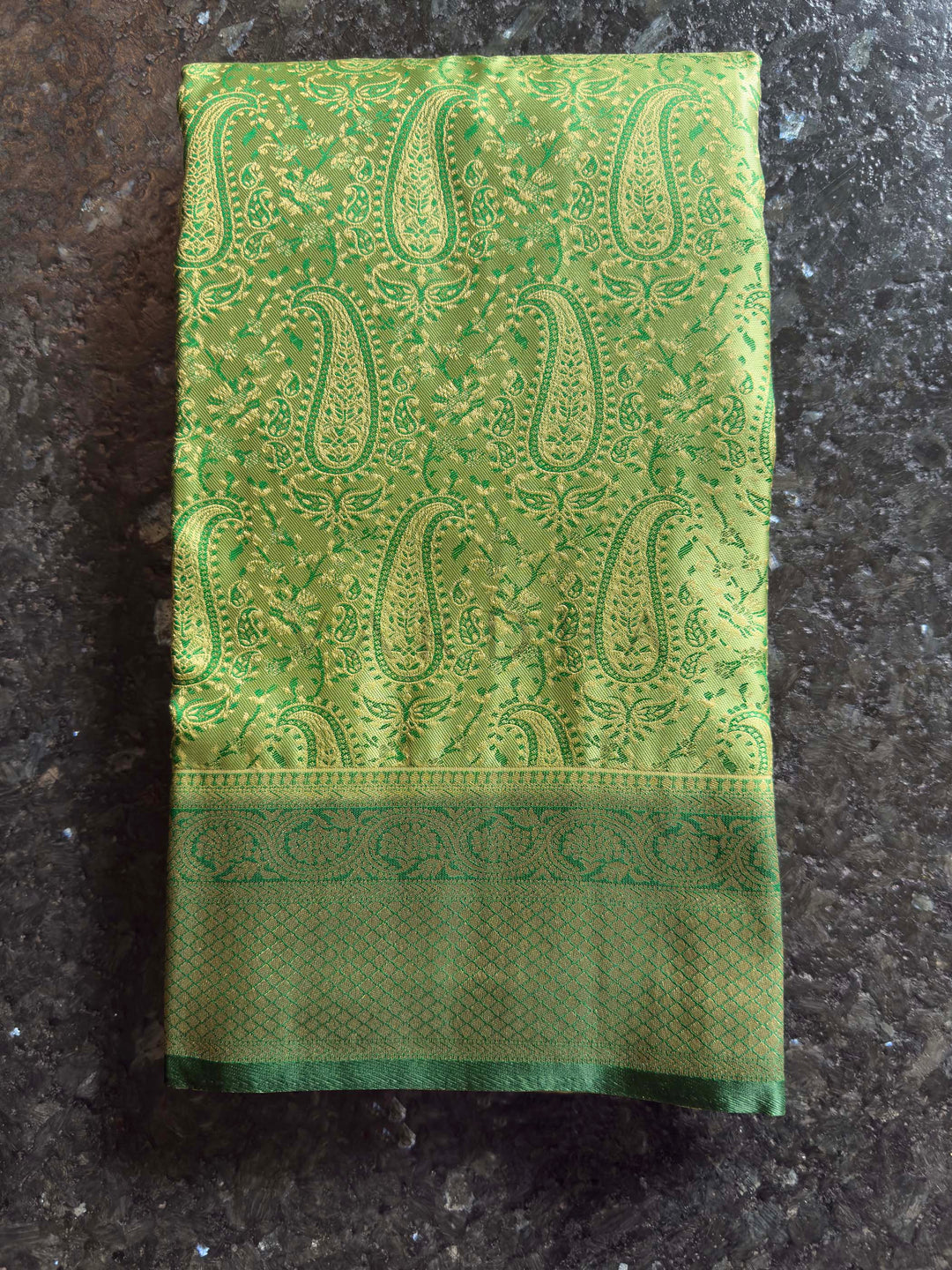 Folded view highlighting the sheen and intricate Tanchoi weave of the satin fabric.