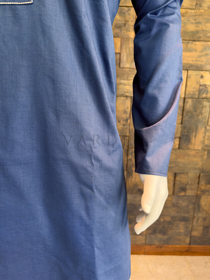 Blue garment on a mannequin against a wooden paneled wall. Premium breathable cotton kurta in a smooth French Blue finish, highlighting the crisp drape and high-quality tailoring.