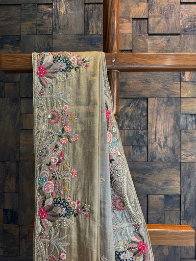 Close-up of floral embroidery with sequins, zari, and resham threads on golden Kanjivaram tissue saree.