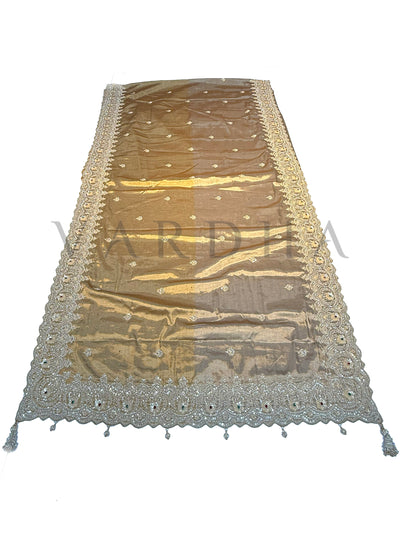 Off White Kanjivaram Tissue Saree with embroidered motifs and floral zari highlights displayed on a wooden stand.