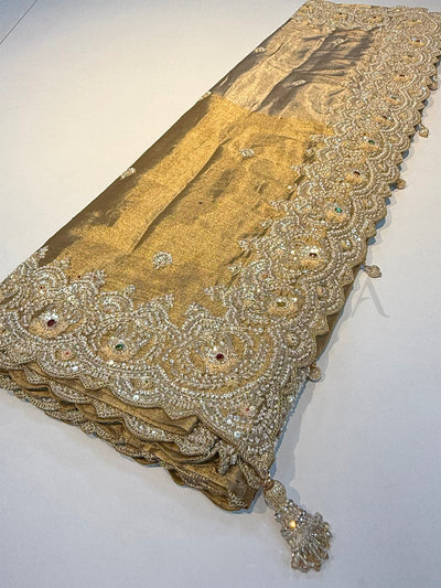 Full-length Off White Kanjivaram Tissue Saree with shimmering body and intricate embroidered pallu.