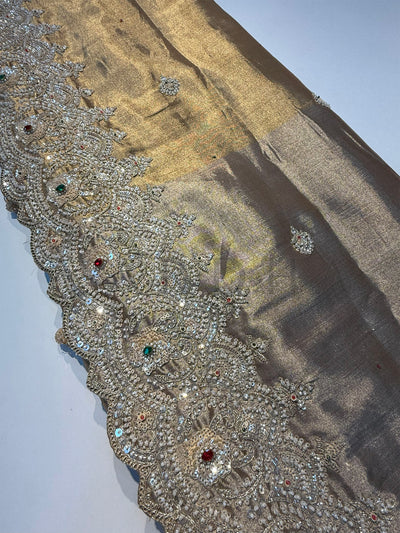 Artistic shot of Off White Saree with vibrant thread embroidery in red, pink, and green.

